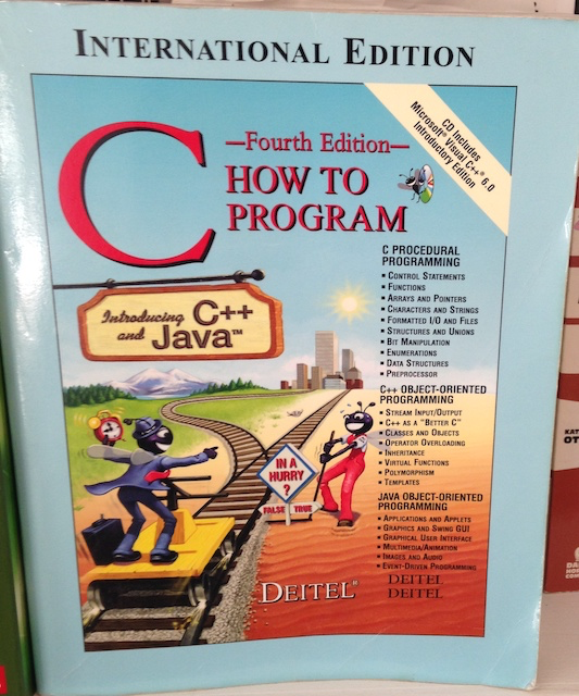 A photo of How to Progam C by Deitel. There are two bugs on the cover going along a train tracks, it looks like they&rsquo;re emulating a philosophical thought experiment